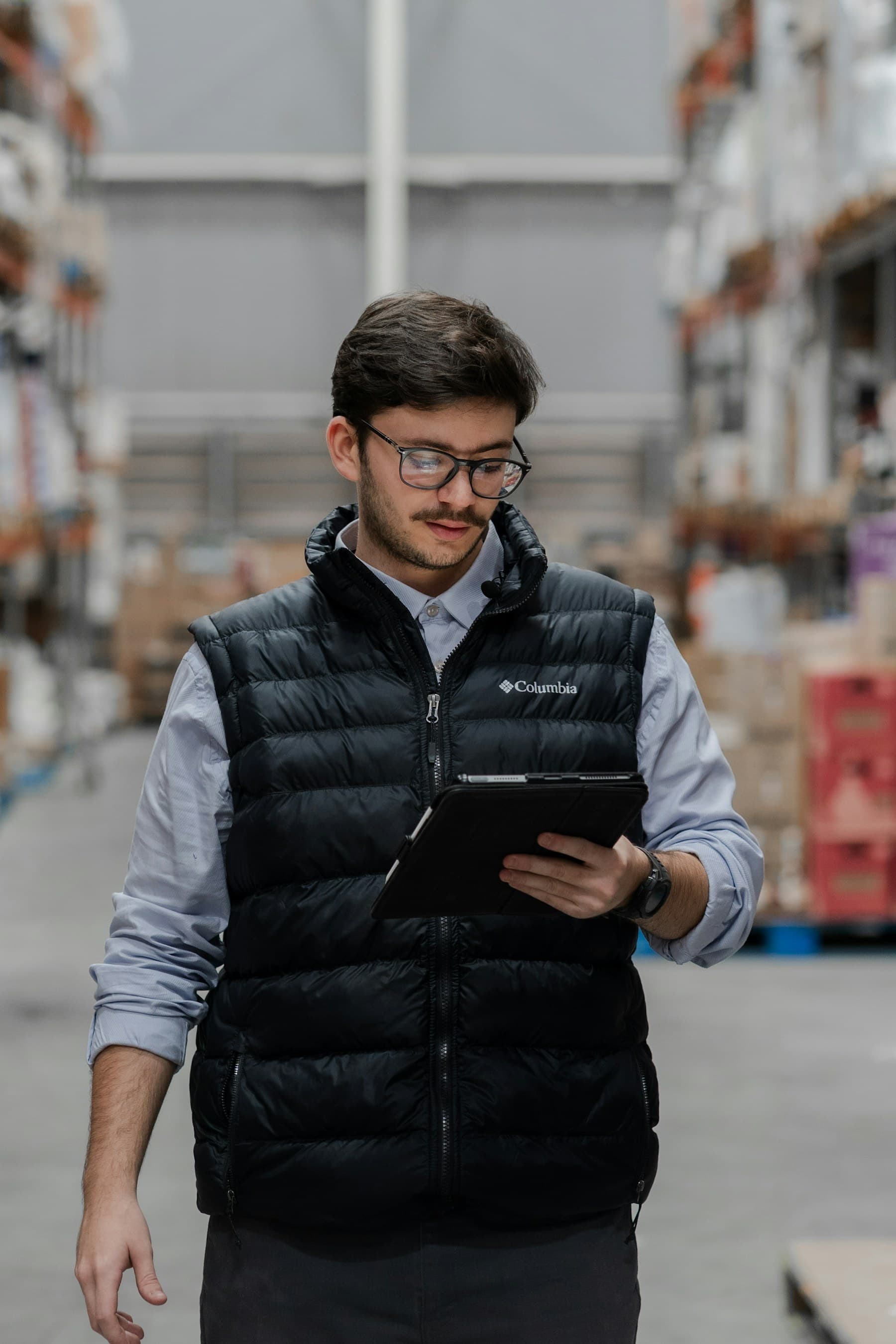 Warehouse operator reviewing supplier pack and product inventory relationships on a tablet